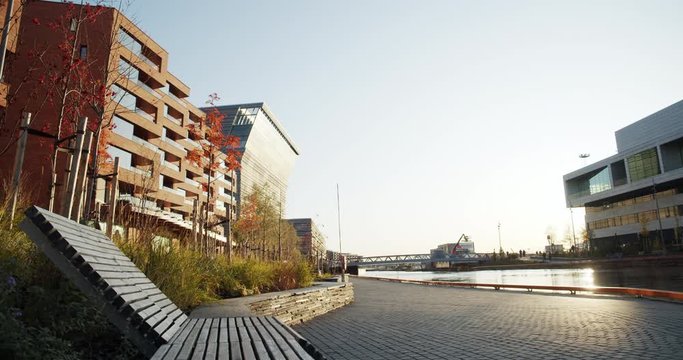 4K low angle wide shot with backward slide motion of Lambda, the new Edvard Munch museum, with famous paintings like The Anxiety, in a late autumn sunset in the Bj&oslash;rvika quarter in Oslo, Norway.