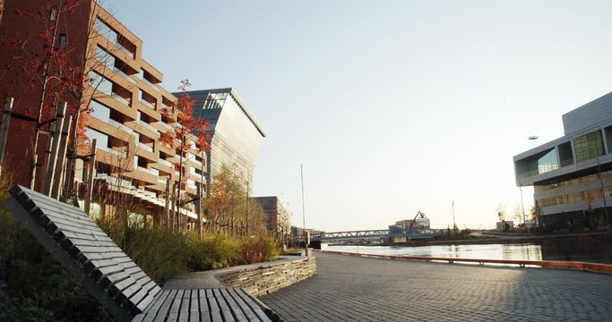 4K low angle wide shot with forward slide motion of Lambda, the new Edvard Munch museum, with famous paintings like The Sick Child, in a late autumn sunset in the Bj&oslash;rvika quarter in Oslo, Norway.