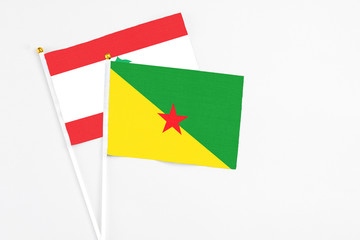 French Guiana and Lebanon stick flags on white background. High quality fabric, miniature national flag. Peaceful global concept.White floor for copy space.