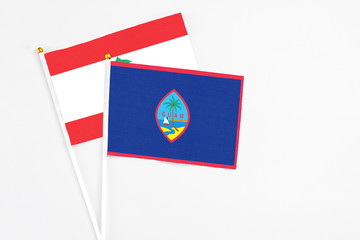 Guam and Lebanon stick flags on white background. High quality fabric, miniature national flag. Peaceful global concept.White floor for copy space.