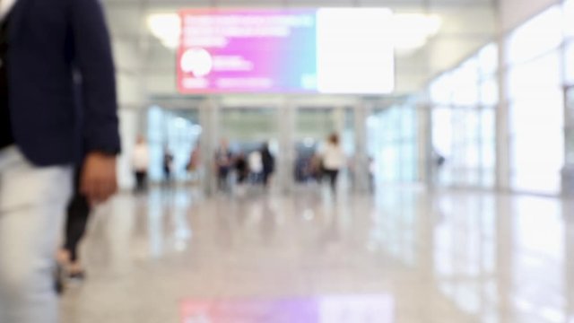 Conference hallway with blurred people passing through