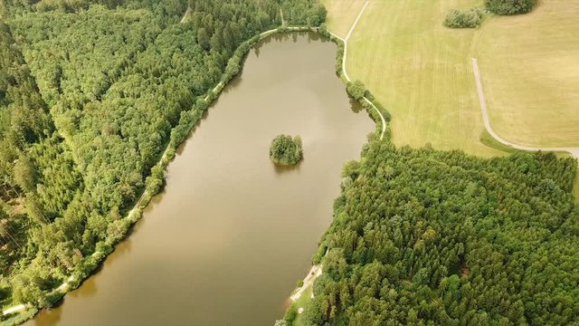 Aerial tracking shot of reservoir lake in countryside
