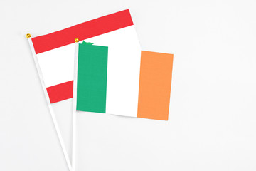Ireland and Lebanon stick flags on white background. High quality fabric, miniature national flag. Peaceful global concept.White floor for copy space.