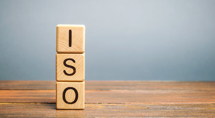 Wooden blocks with the word ISO. International organization for standardization. Quality standard