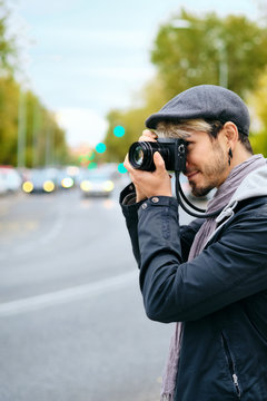 Hipster Photographer Taking Street Pictures With Mirrorless Camera