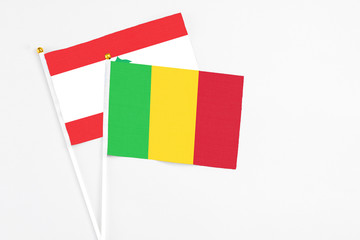 Mali and Lebanon stick flags on white background. High quality fabric, miniature national flag. Peaceful global concept.White floor for copy space.