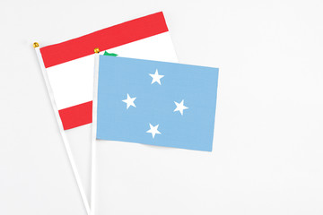 Micronesia and Lebanon stick flags on white background. High quality fabric, miniature national...