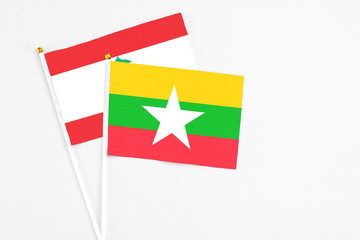 Naklejka premium Myanmar and Lebanon stick flags on white background. High quality fabric, miniature national flag. Peaceful global concept.White floor for copy space.