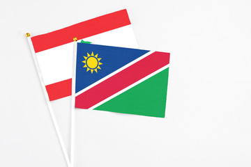 Namibia and Lebanon stick flags on white background. High quality fabric, miniature national flag. Peaceful global concept.White floor for copy space.
