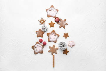 Christmas tree shape made of tasty cookies on white background