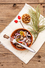 Pickled (fermented) mushrooms. Traditional New Year (Christmas) snack. Festive table cutlery setting