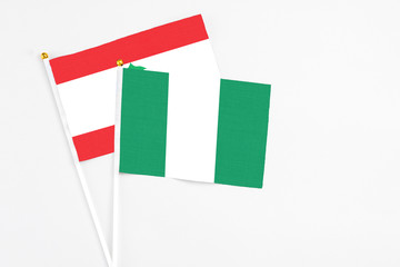 Nigeria and Lebanon stick flags on white background. High quality fabric, miniature national flag. Peaceful global concept.White floor for copy space.