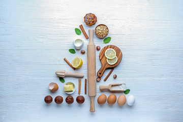 Christmas tree shape made of products and utensils on white background