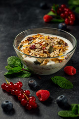 Yogurt with berries and granola in bowl