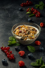 Yogurt with berries and granola in bowl