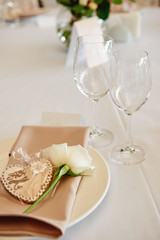 Table setting with sparkling wineglasses and cutlery on table, copy space. Menu mockup, place setting at wedding reception. Table served for wedding banquet in restaurant