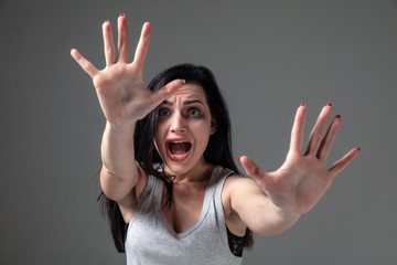 Woman in fear of domestic abuse and violence, concept of female rights. Stop agression. Caucasian...