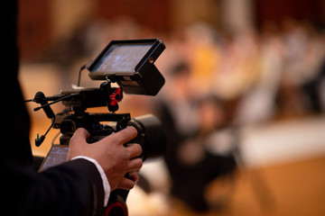 Behind the scenes of movie shooting or video production and film crew team with camera equipment at outdoor location