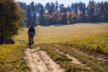 Obraz premium Cyclist ride on the bike path, Autumn bike ride