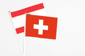Switzerland and Lebanon stick flags on white background. High quality fabric, miniature national flag. Peaceful global concept.White floor for copy space.