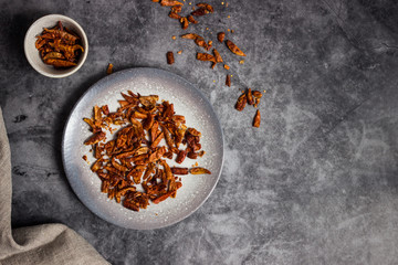A dish with dry red chillis over a black background