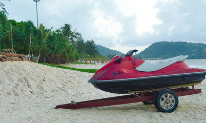 The jet ski is loaded on a trolley, prepared for transportation along the beach