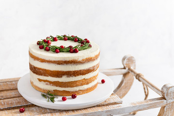 Homemade Christmas cake on a rustic wooden sledge on white background. New Year, bakery, confectionery concept