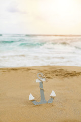 Fototapeta na wymiar Wide coast and anchor in the sand by the sea. - Picture