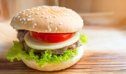 hamburger  background is natural wooden. Concept  Breakfast in rush hour.