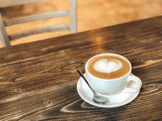 Cup of coffee on wooden table