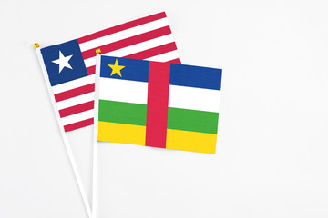 Central African Republic and Liberia stick flags on white background. High quality fabric, miniature national flag. Peaceful global concept.White floor for copy space.