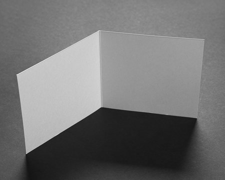 Square postcard mock-up on black paper background