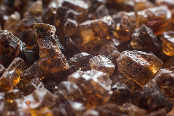 Amber mineral texture as natural background. Sun stones of different sizes, shapes and colors. A lot of big and small diggers. Fossil resin of wood. Material for jewelry. Depth of field, macro stone