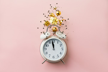 Christmas or New Year composition on pink background with retro alarm clock and Christmas...