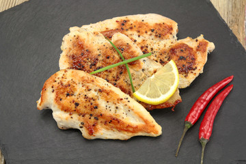 grilled chicken cutlets on a plate