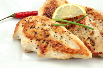 grilled chicken cutlets on a plate