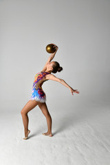 girl in gymnastic suit with golden ball