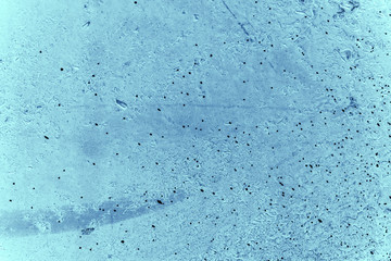 Vintage blue background. Rough painted wall of sapphire color. Imperfect plane of blue colored. Uneven old decorative toned backdrop of cyan tint. Texture of sapphirine hue. Ornamental stony surface.