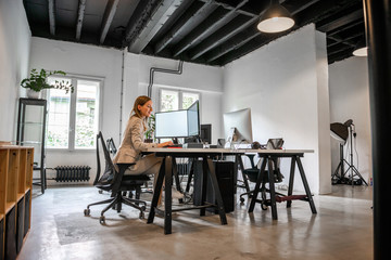 Young beautiful woman working in her office