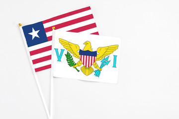 United States Virgin Islands and Liberia stick flags on white background. High quality fabric, miniature national flag. Peaceful global concept.White floor for copy space.