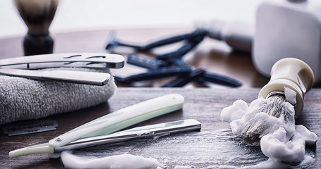 Shaving accessories on a wooden texture background. Tools. Disposable shaving machine, brush, foam and hazard razor.