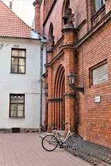 Fototapeta na wymiar Riga, Latvia, November 2019. Bicycle parking at the wall of an old medieval temple.