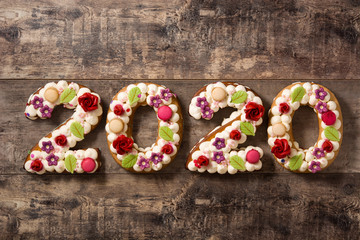 2020 cake on wooden table. New year concept.	