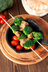 Vegetarian kebabs with seitan and broccoli on a skewers.