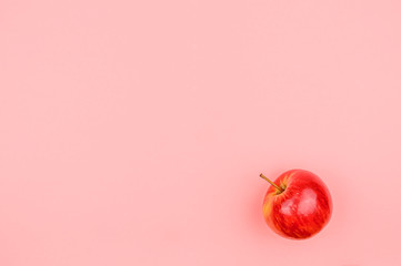 Organic apple on a pink background.