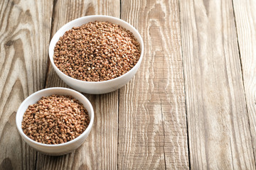 Buckwheat in a light bowl on a rustic background copy space.