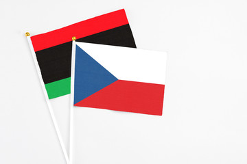 Czech Republic and Libya stick flags on white background. High quality fabric, miniature national flag. Peaceful global concept.White floor for copy space.
