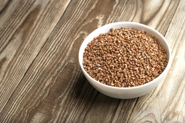 Buckwheat in a light bowl on a rustic background copy space.