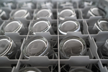 Close up of glasses in a basket for an automatic dishwasher machine.