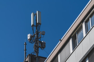 Fototapeta na wymiar 5G mobile networks operator antennas on a building roof